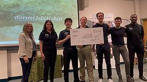 Photo of 2023 winning U-Pitch team with banner showing $5,000 win